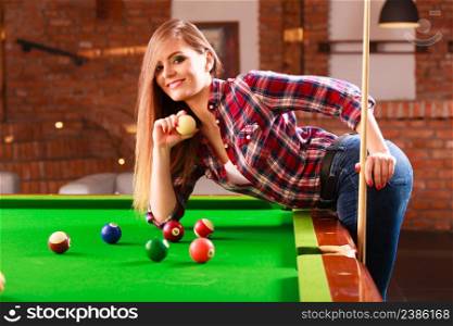 Fashion and fun concept. Young charming girl posing by billiard pool. Attractive fashionable woman casual style spending time on recreation.. Young woman having fun with billiard.