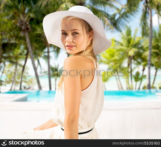 fashion and lifestyle concept - beautiful woman in hat enjoying summer outdoors