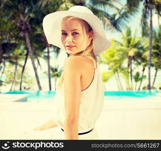 fashion and lifestyle concept - beautiful woman in hat enjoying summer outdoors