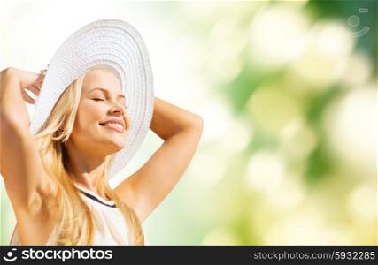 fashion and lifestyle concept - beautiful woman in hat enjoying summer outdoors. beautiful woman enjoying summer outdoors