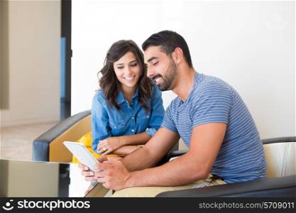 Fashion and modern couple sitting together with tablet