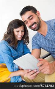 Fashion and modern couple sitting together with tablet