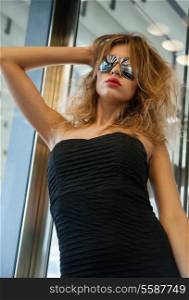 fashion and people concept - beautiful woman in sunglasses in elevator