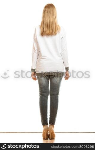 Fashion and people concept. Woman full length in denim trousers high heels shoes casual style white blank blouse back view isolated on white background