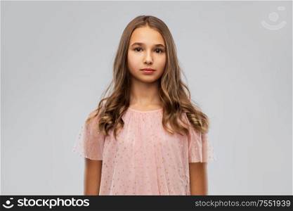 fashion and people concept - young teenage girl in party dress over grey background. young teenage girl in party dress
