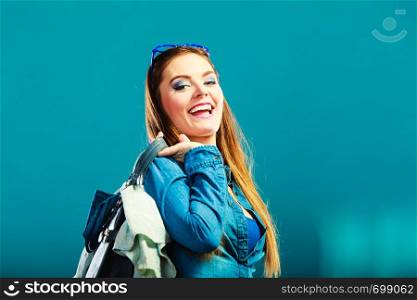 Fashion and shopping. Woman long hair wearing denim with bag. Attractive girl holding handbag with jeans clothes, buying. Blue color