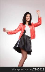 Fashion and style. Beauty gorgeous young mixed race woman wearing stylish red jacket coat and black leather skirt. Fashionable girl posing indoor.