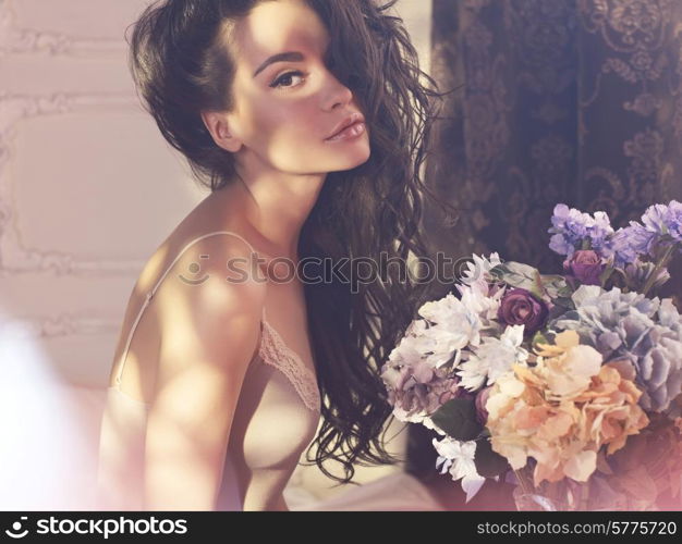 Fashion art photo of beautiful lady with flowers. Home interior. Morning