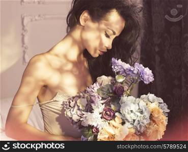 Fashion art photo of beautiful lady with flowers. Home interior. Morning