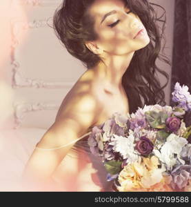 Fashion art photo of beautiful lady with flowers. Home interior. Morning