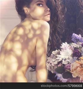 Fashion art photo of beautiful lady with flowers. Home interior. Morning