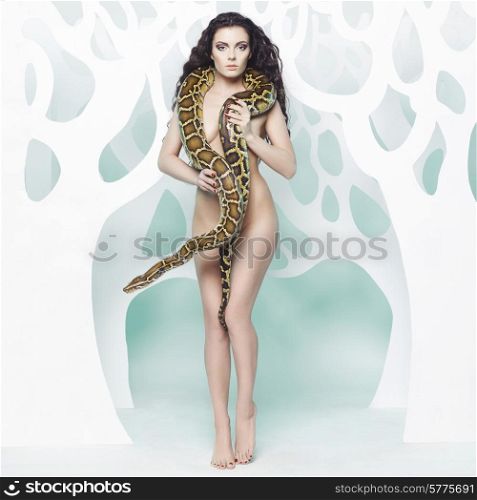 Fashion art photo of beautiful nude woman with python