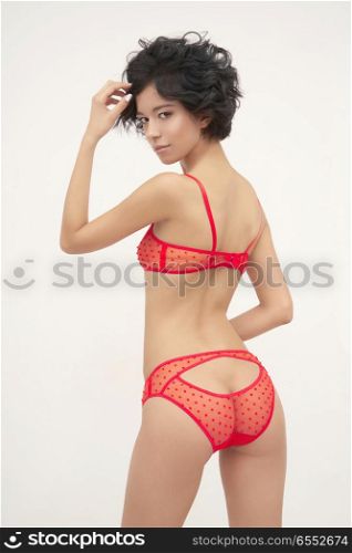 Fashion art photo of beautiful sensual woman in red erotic lingerie. Designer underwear