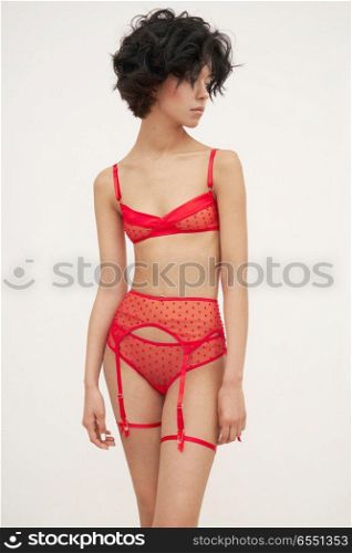 Fashion art photo of beautiful sensual woman in red lace lingerie. Designer underwear