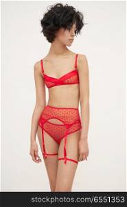 Fashion art photo of beautiful sensual woman in red lace lingerie. Designer underwear