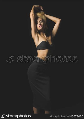 Fashion-art photo of elegant blonde on black background