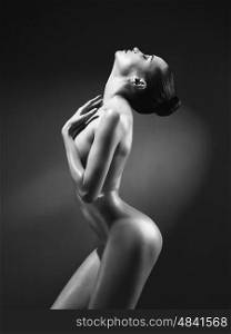fashion art photo of elegant nude model in the light colored spotlights