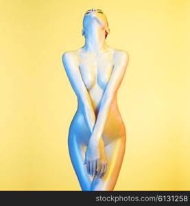 Fashion art photo of elegant nude model in the light colored spotlights