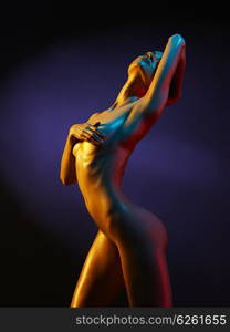 fashion art photo of sexy nude stripper in the night-club. Perfect female body with oil skin