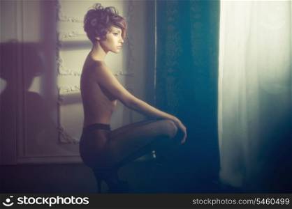 Fashion art photo of young sensual lady in classical interior