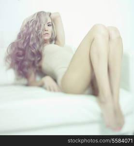 Fashion art photo of young sensual lady in white interior