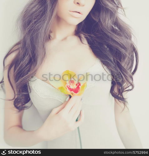 Fashion art portrait of beautiful lady with delicate flowers