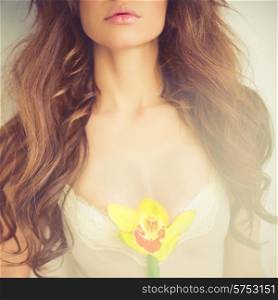 Fashion art portrait of beautiful lady with delicate flowers