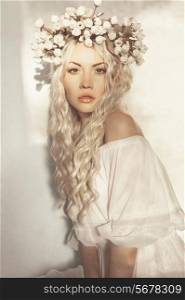 Fashion-art portrait of romantic blonde with wreath of flowers