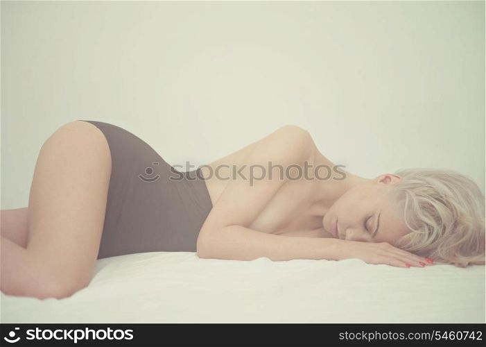 Fashion art portrait of young elegant woman in bed