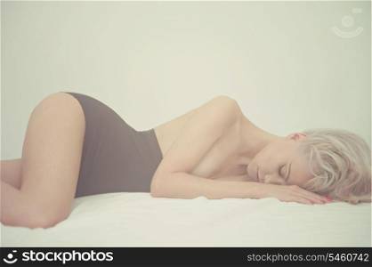 Fashion art portrait of young elegant woman in bed