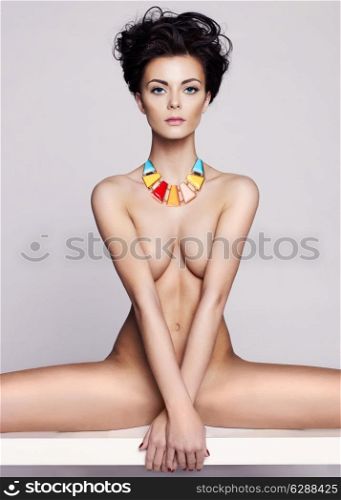 Fashion art studio photo of elegant naked lady with jewelry