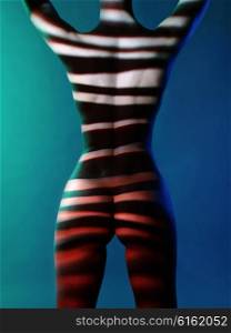 Fashion art studio photo of elegant naked lady with shadows on her body