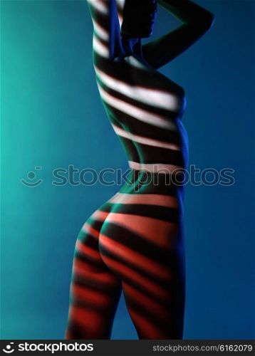 Fashion art studio photo of elegant naked lady with shadows on her body