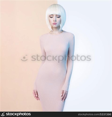 Fashion art studio portrait of elegant blonde in geometric beige and white background. Fashion and style in advertising
