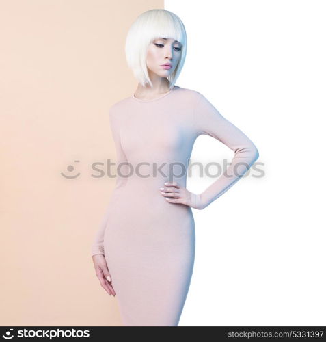 Fashion art studio portrait of elegant blonde in geometric beige and white background. Fashion and style in advertising
