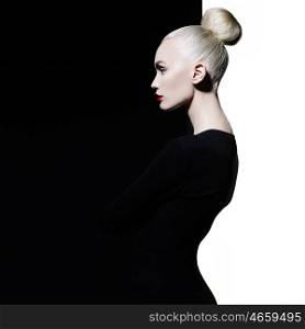 Fashion art studio portrait of elegant blonde in geometric black and white background