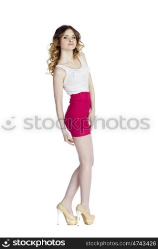 Fashion beautiful girl with modern white blouse and res skirt posing in studio, isolated on white