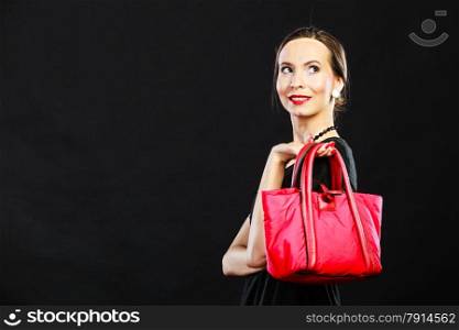 Fashion beauty and elegance concept. Woman retro style. Elegant lady holding red handbag on black