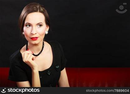 Fashion beauty and elegance concept. Woman retro style portrait. Elegant lady hair styling red lips on black