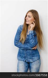 Fashion, beauty, people, jeans concept. Beautiful model posing in the studio. Young lady wearing denim shirt.