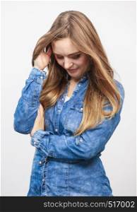 Fashion, beauty, people, jeans concept. Beautiful model posing in the studio. Young lady wearing denim shirt. . Beautiful model posing in the studio.