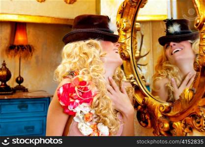 fashion blond woman with hat looking in baroque golden frame mirror