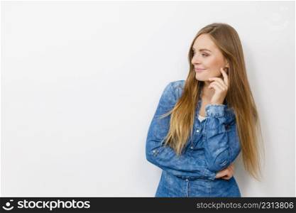 Fashion, clothing, people concept. Attractive young woman with jeans jacket. Girl is posing in the studio.. Beautiful young lady with denim jacket.