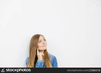 Fashion, clothing, people concept. Attractive young woman with jeans jacket. Girl is posing in the studio.. Beautiful young lady with denim jacket.