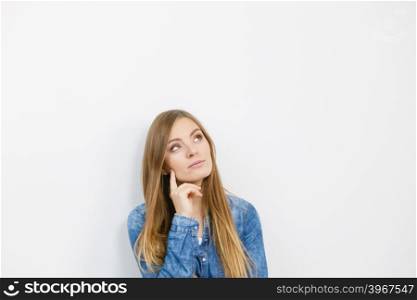 Fashion, clothing, people concept. Attractive young woman with jeans jacket. Girl is posing in the studio.