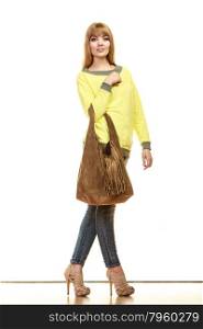 Fashion concept. Full body fashionable woman in full length holding brown shoulder fringe handbag isolated on white