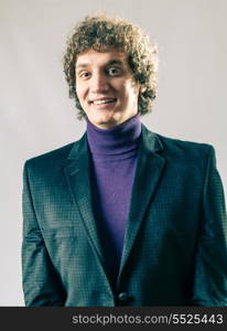 Fashion curly haired white man in studio