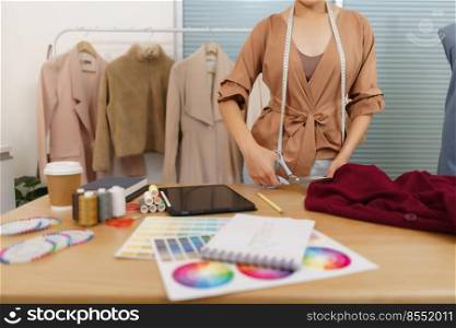 Fashion design concept, Asian female fashion designer is tailoring clothes for the new collection.