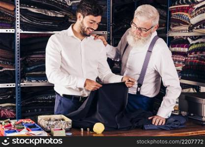 fashion designer customer looking fabric his shop