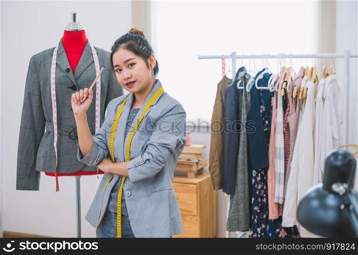 Fashion designer stylist in business owner workshop. Tailor and sewing concept. Portrait of happy casual trendy fashion designer businesswoman in studio looking camera. Business job and occupation